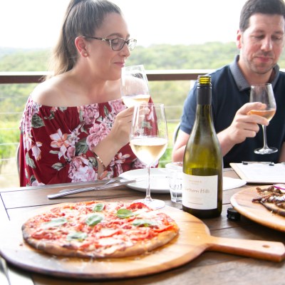guests eating pizza and drinking wine